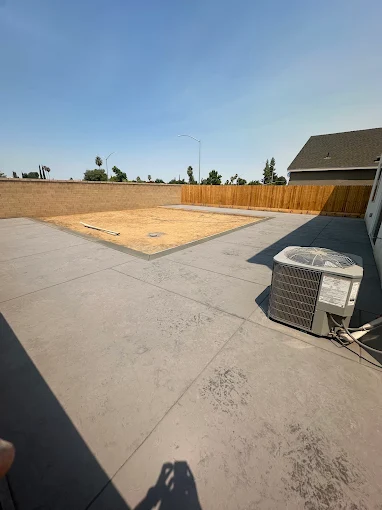 Finished concrete flatwork across a Fresno backyard